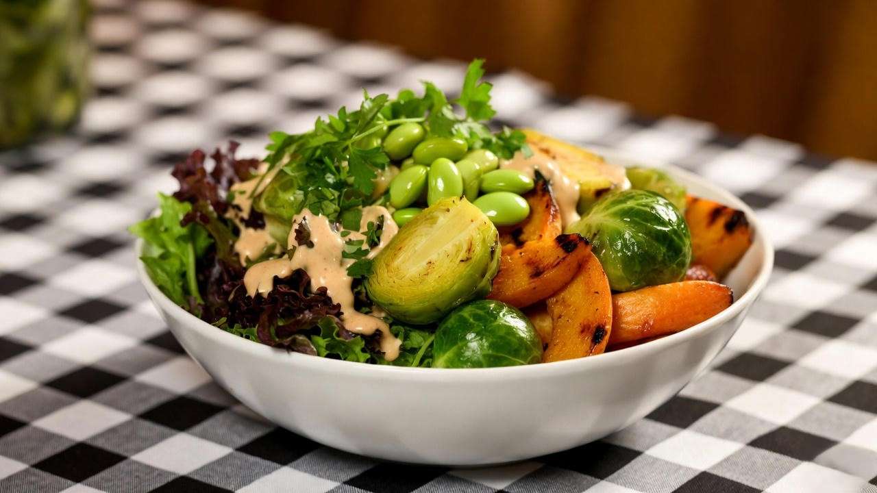 Customizable plant-powered BBQ bowl with greens, grilled veggies, edamame, and vinegar sauce from Mission BBQ catering menu
