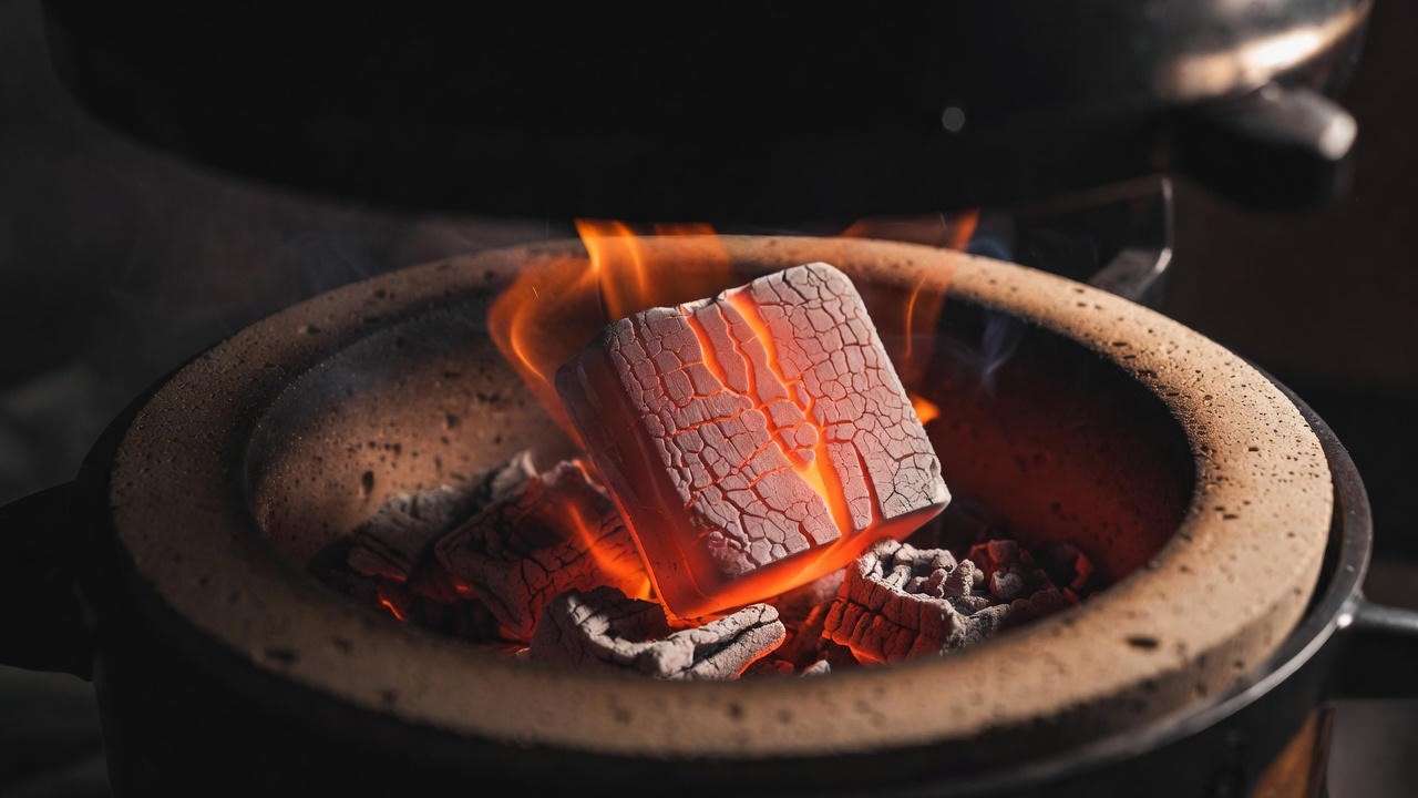 Glowing binchotan charcoal inside authentic Japanese yakitori grill konro