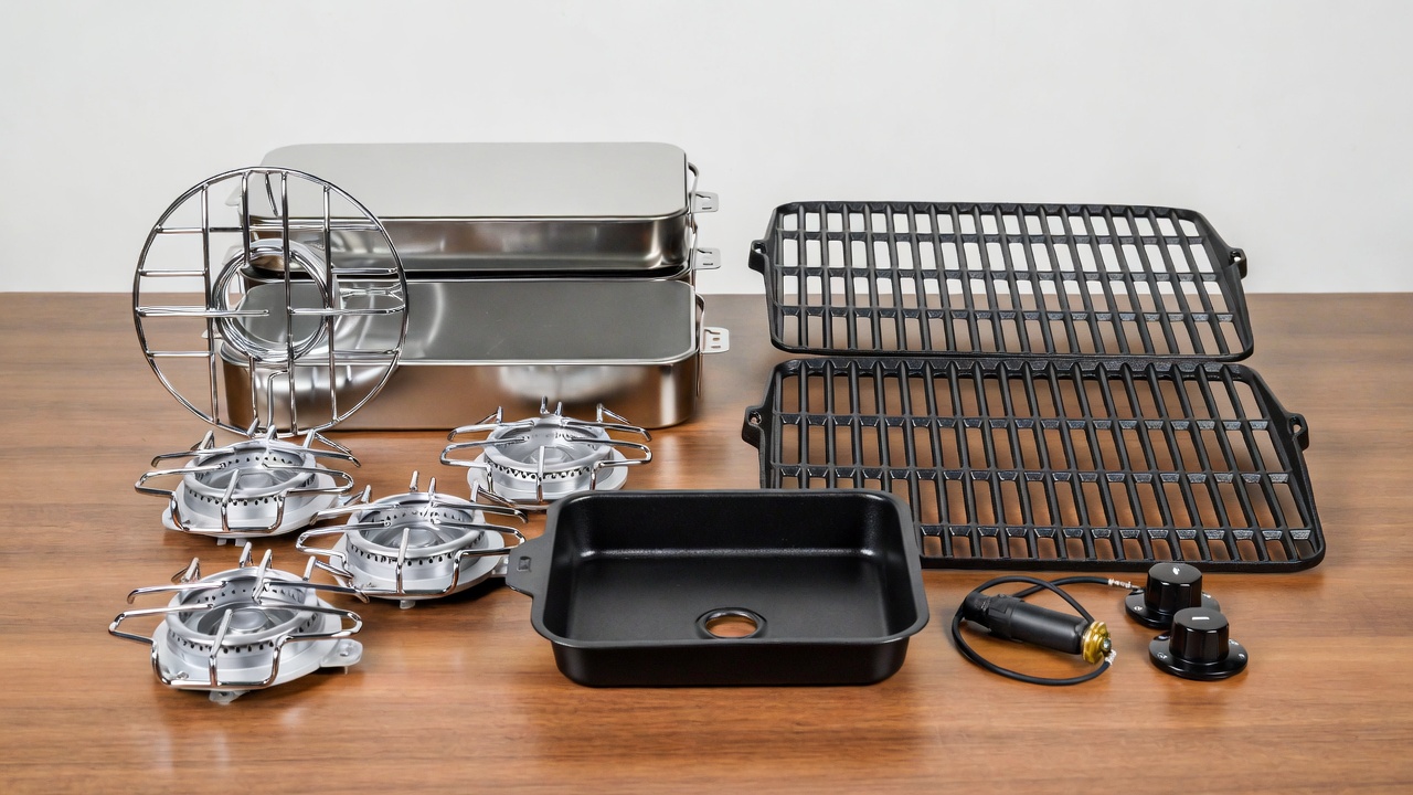 Assortment of essential Dyna-Glo grill replacement parts including burners, heat plates, grates, and grease tray