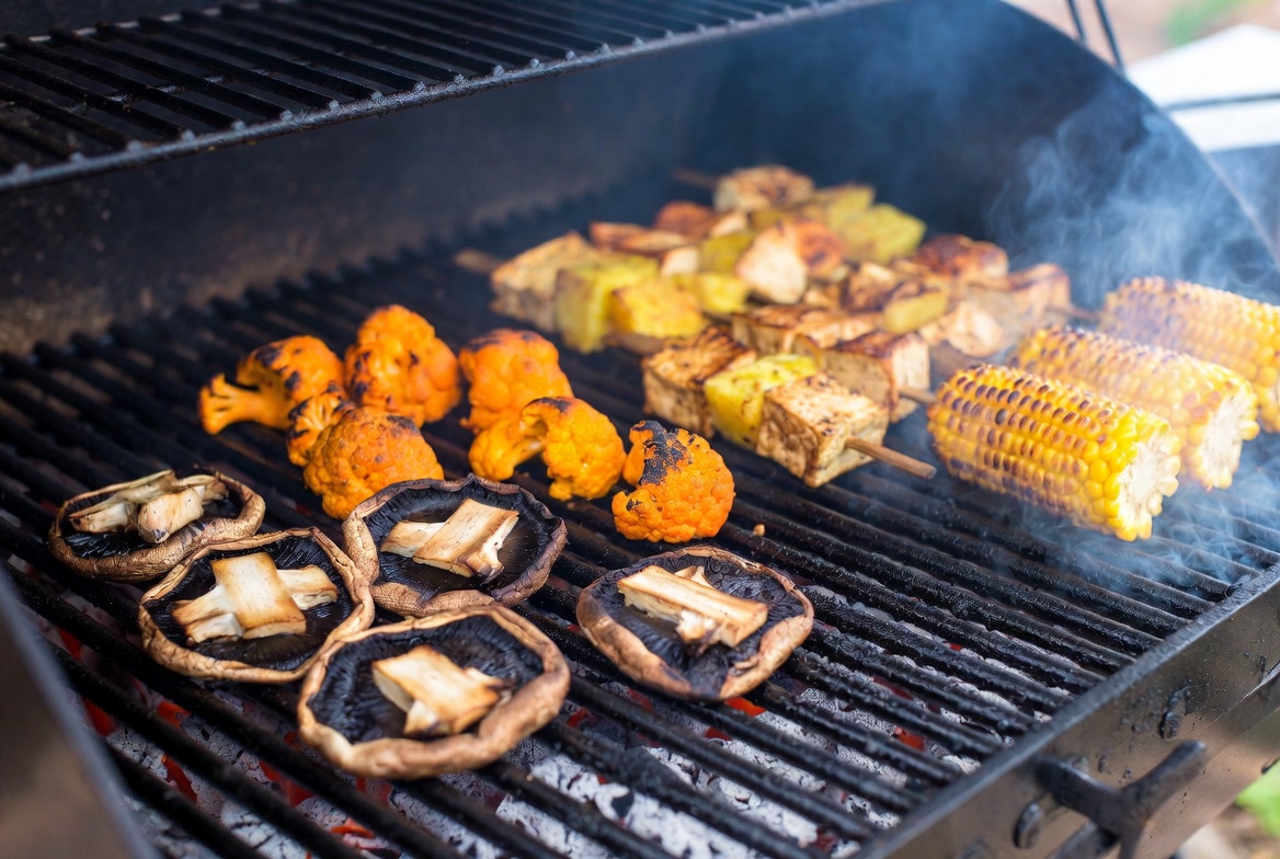 Plant-based ingredients on pellet grill with char marks and smoke